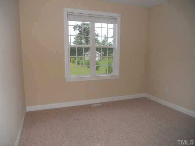 5939 Sandford Road Wilson, NC 27896 - Photo 9 of 10 an empty room with a window