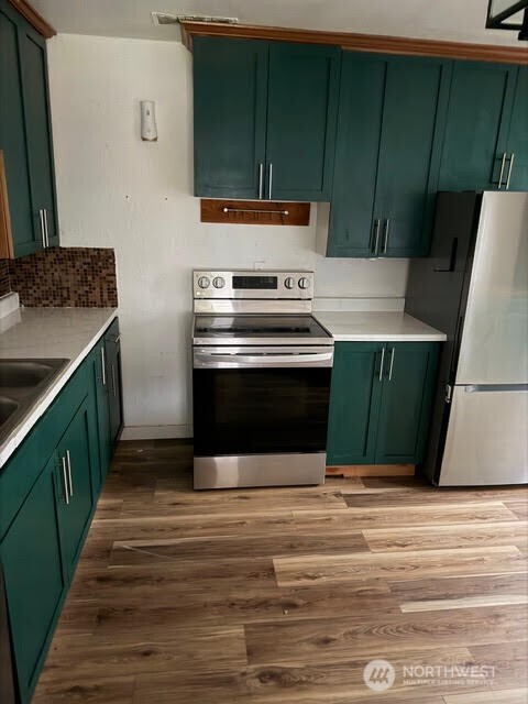 3715 Spokane Street Tacoma, WA 98404 - Photo 11 of 22 a kitchen with kitchen island a sink and a stove