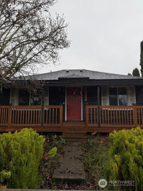 3715 Spokane Street Tacoma, WA 98404 - Photo 2 of 22 a view of a house with a small yard and wooden fence