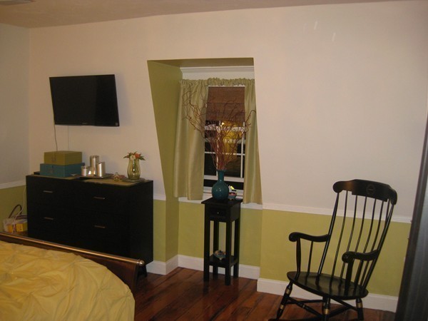 73 Walnut Avenue, Unit 3 Boston, MA 02119 - Photo 16 of 19 a bedroom with a bed and wooden floor