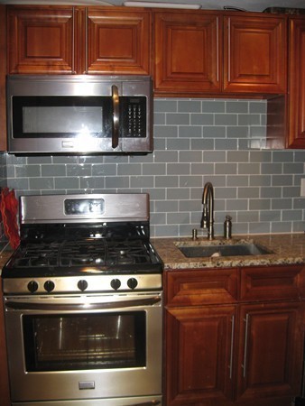 73 Walnut Avenue, Unit 3 Boston, MA 02119 - Photo 5 of 19 a stove top oven sitting inside of a kitchen