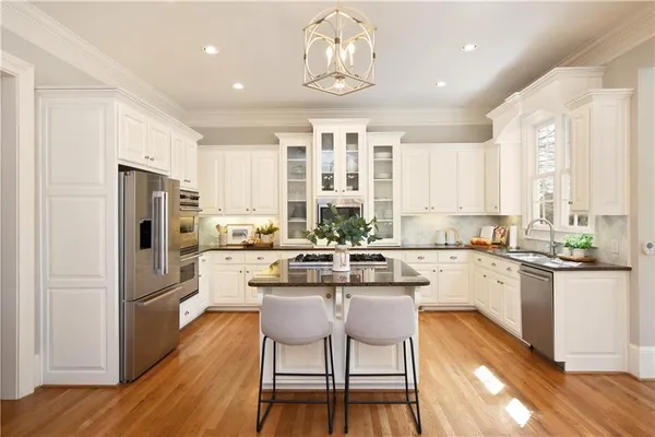a spacious bedroom with a bed and glass walk in closet