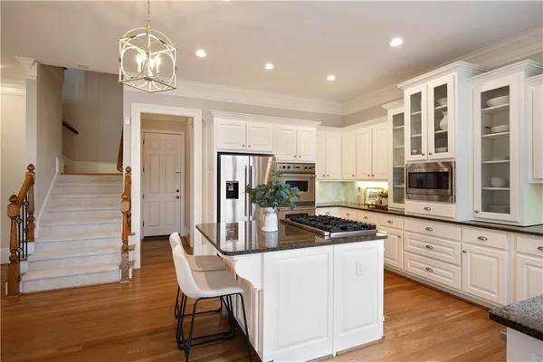 a bathroom with a granite countertop sink toilet and a mirror