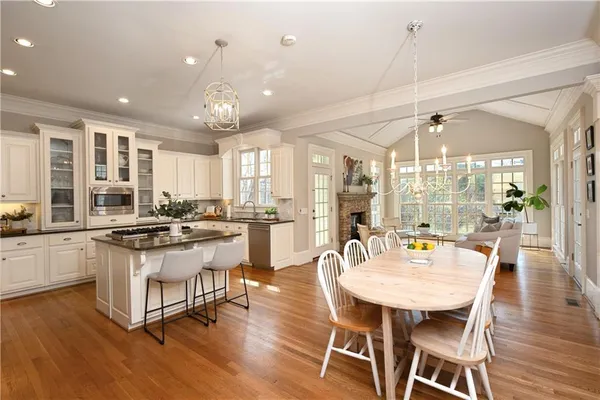 a spacious bathroom with a sink double vanity granite and a large mirror