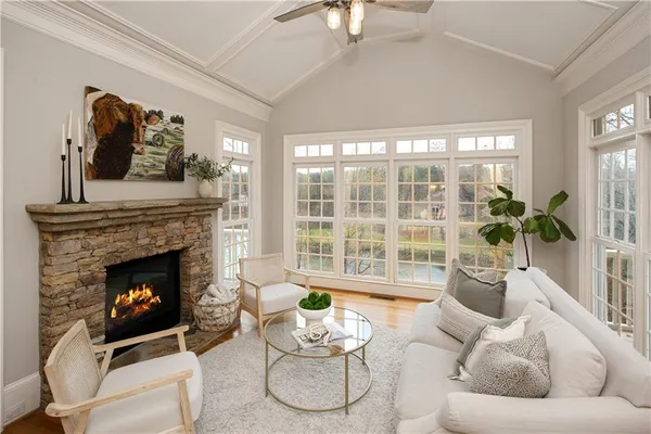 a bathroom with a bathtub a shower and a window
