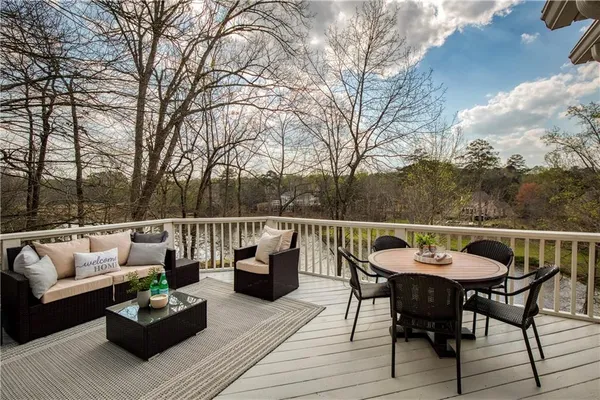 a spacious bathroom with a tub sink and mirror
