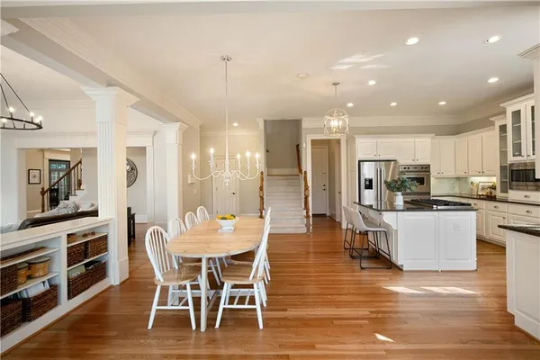 a spacious bedroom with a bed and a chandelier