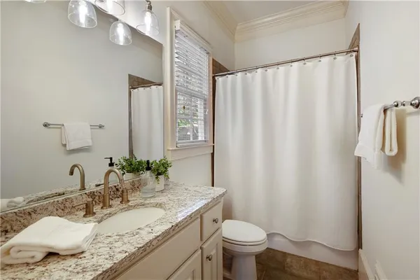 a bathroom with a toilet a sink and a mirror