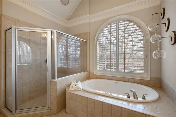 a living room with furniture a flat screen tv and a window