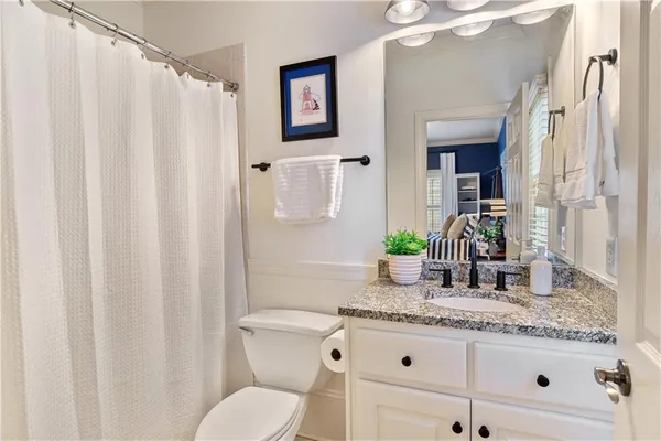 an aerial view of a house with swimming pool and outdoor seating