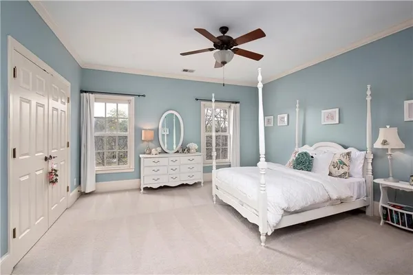 a view of a patio with table and chairs and potted plants with wooden floor and fence