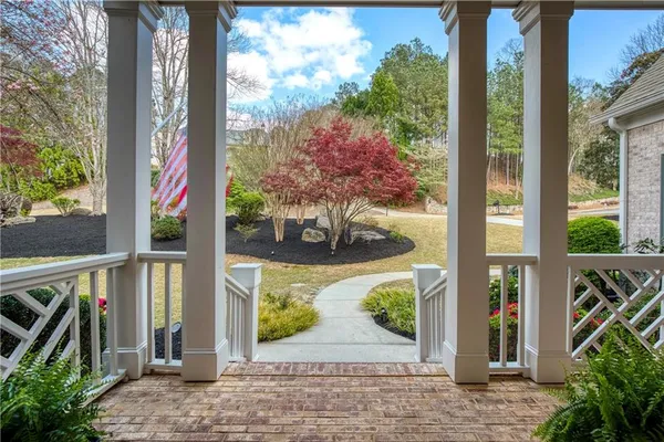 a living room with furniture a fireplace and a large window