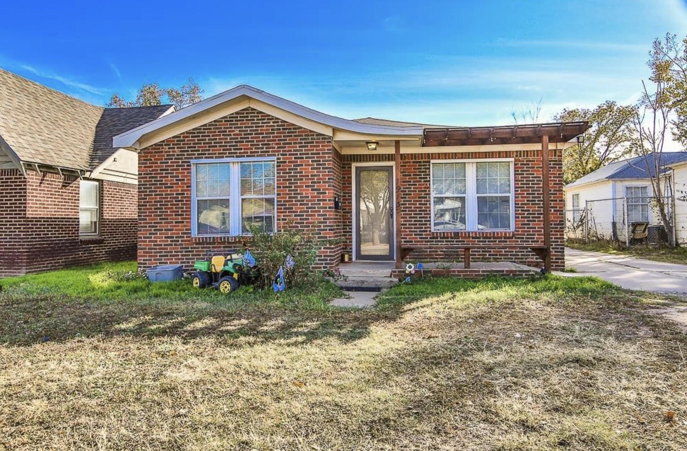 1913 27th Street Lubbock, TX 79411 - Photo 1 of 12 a front view of a house with garden