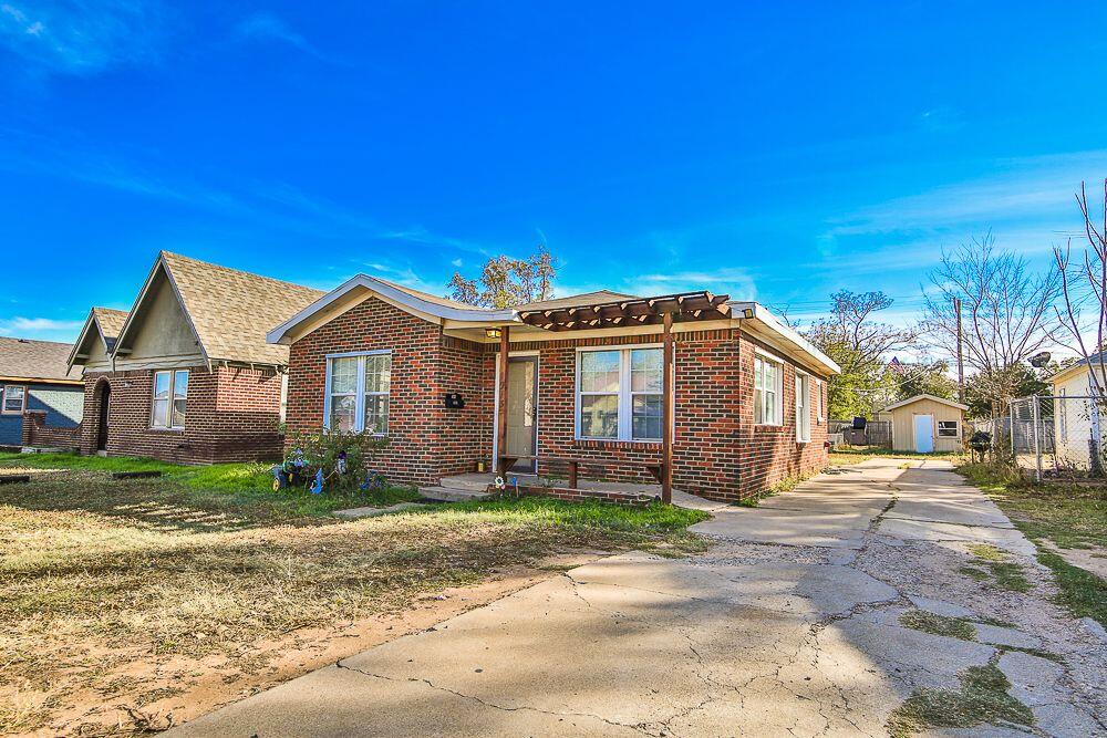 1913 27th Street Lubbock, TX 79411 - Photo 2 of 12 a front view of a house with a yard