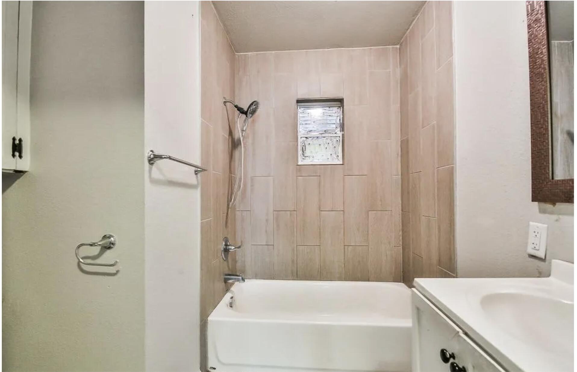 1913 27th Street Lubbock, TX 79411 - Photo 6 of 12 a bathroom with a tub and a sink