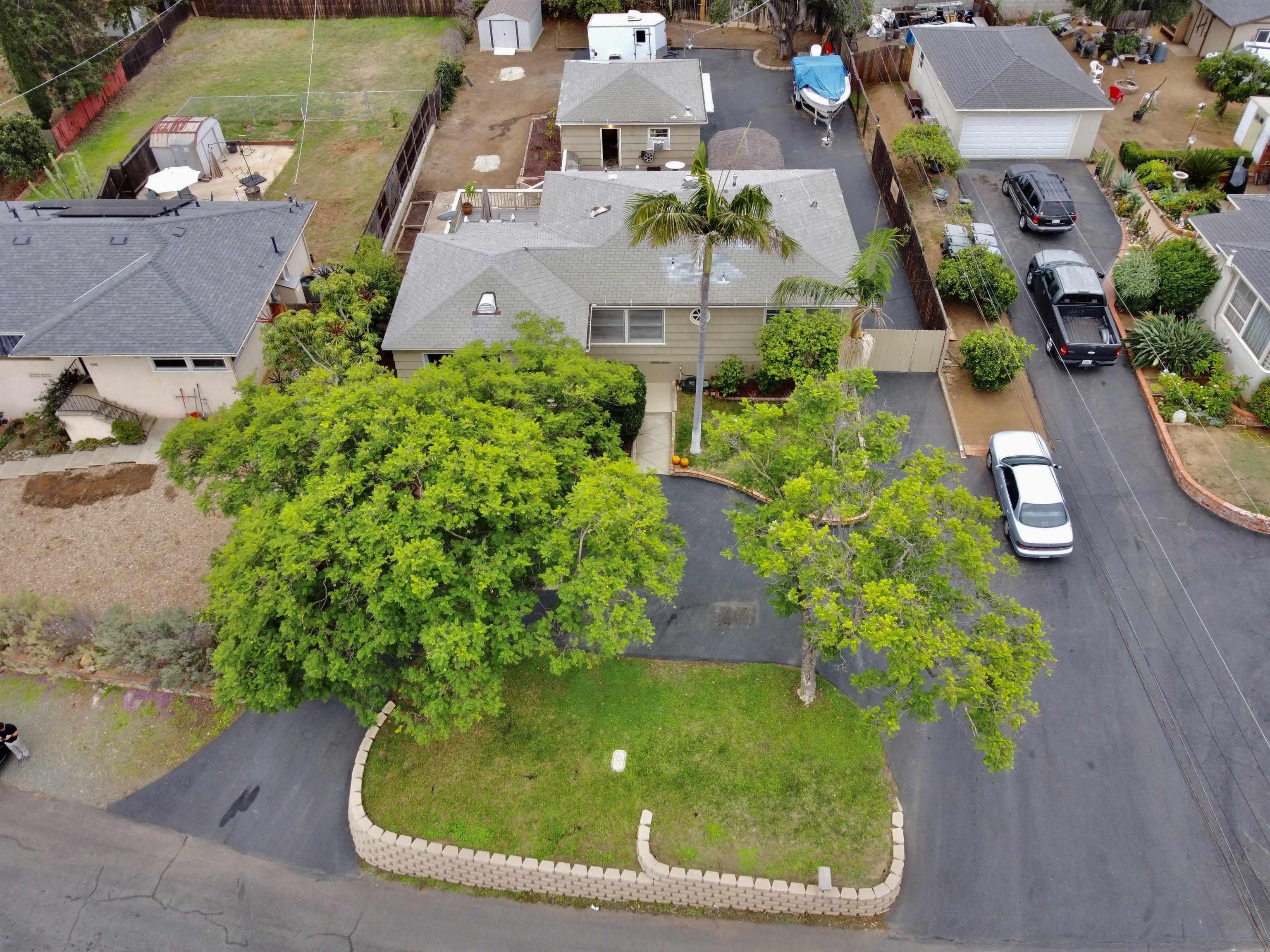 an aerial view of a house with a yard and potted plants