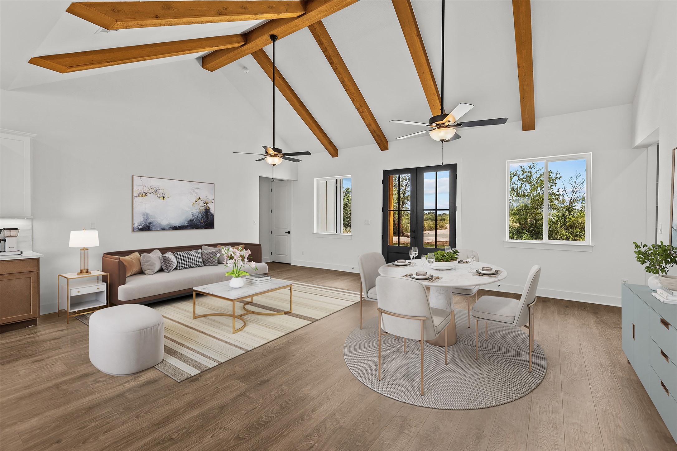 1420 Barth Road Dale, TX 78616 - Photo 4 of 37 Exposed wood beams adorn the vaulted ceiling of this inviting living and dining area, featuring durable plank flooring and sun-filled windows.