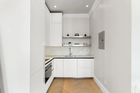 a kitchen with a sink a stove and cabinets