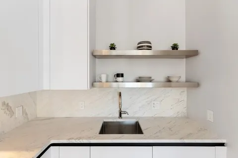 a kitchen with a sink and cabinets