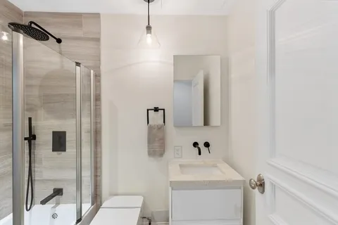 a bathroom with a sink toilet and shower