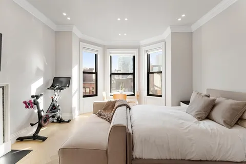 a bed room with a bed and a large window