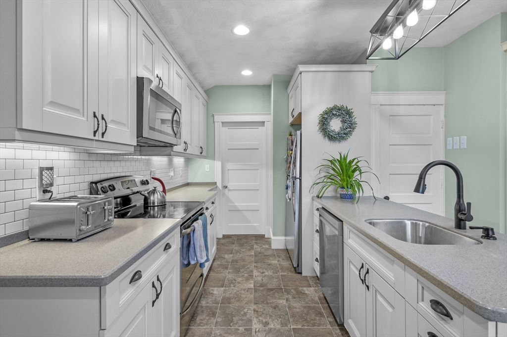 9 Pickman Road Salem, MA 01970 - Photo 11 of 31 a kitchen with a sink and a stove top oven