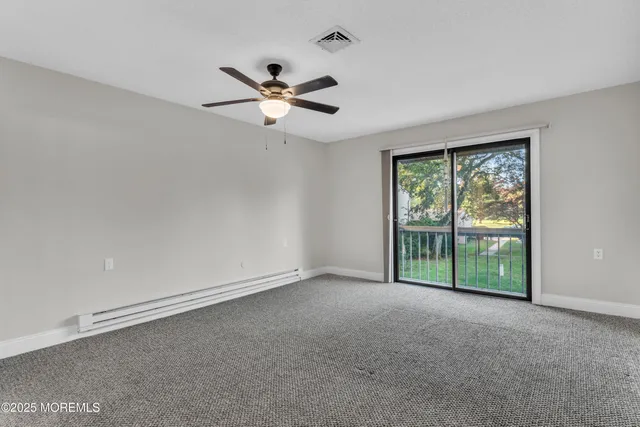 a view of room with window and ceiling fan
