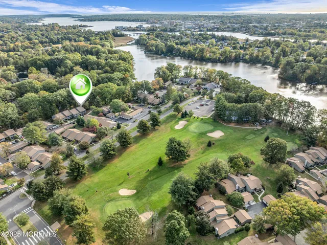 view of a city with lots of green and white house