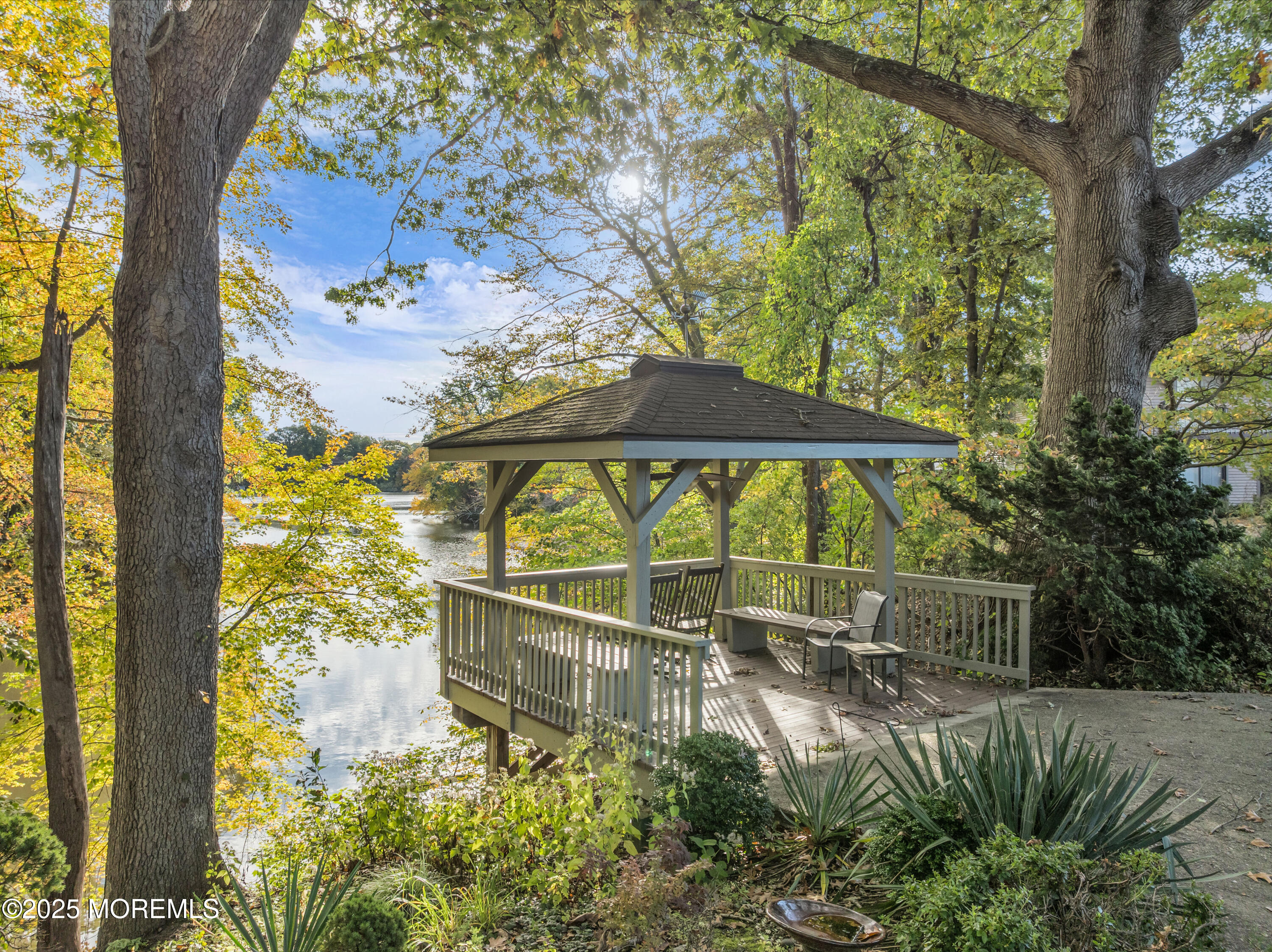 33 Auburn Court Red Bank, NJ 07701 - Photo 21 of 23 a backyard of a house with table and chairs under an umbrella