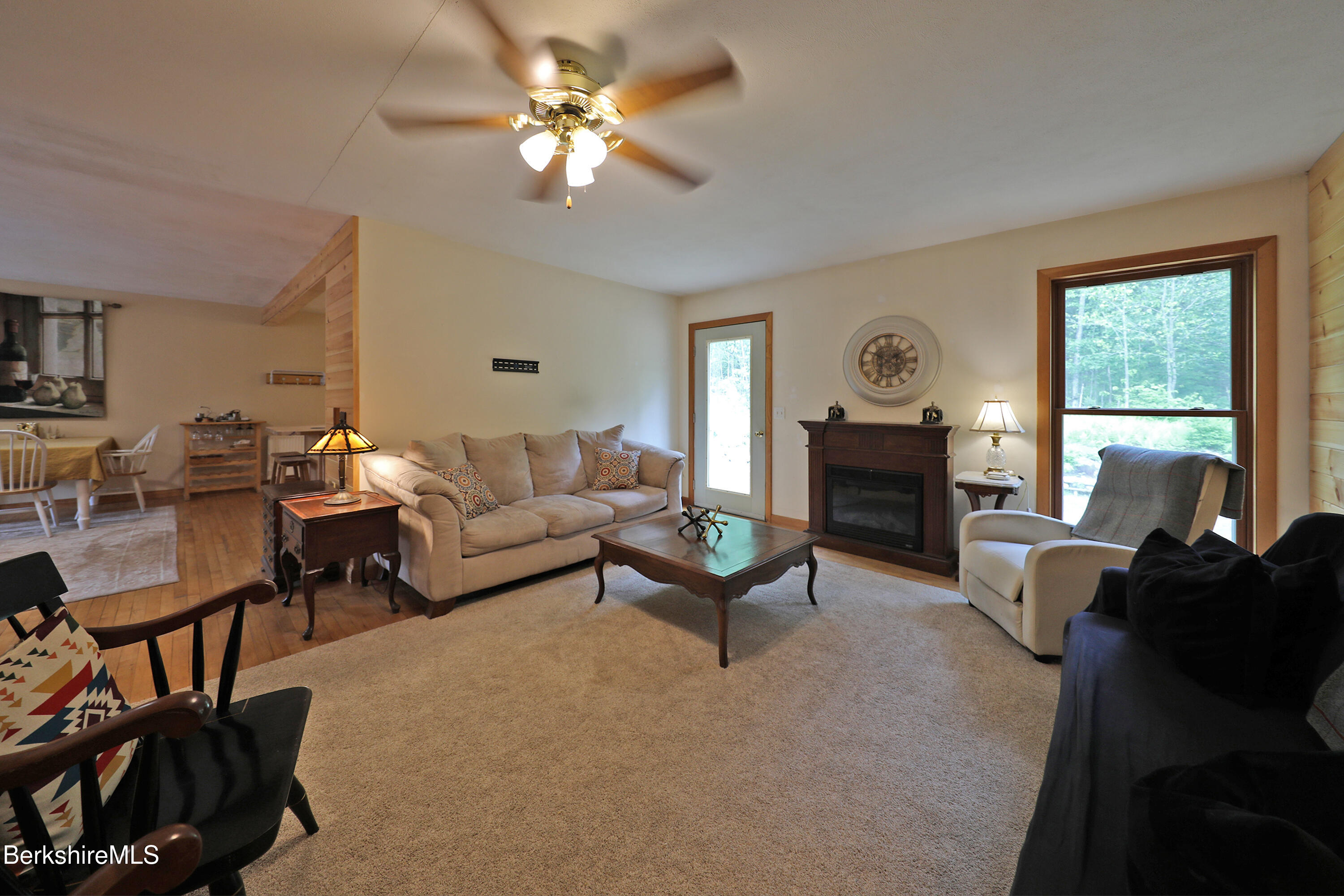 289 Algerie Road Becket, MA 01223 - Photo 11 of 33 a living room with furniture fireplace and a large window