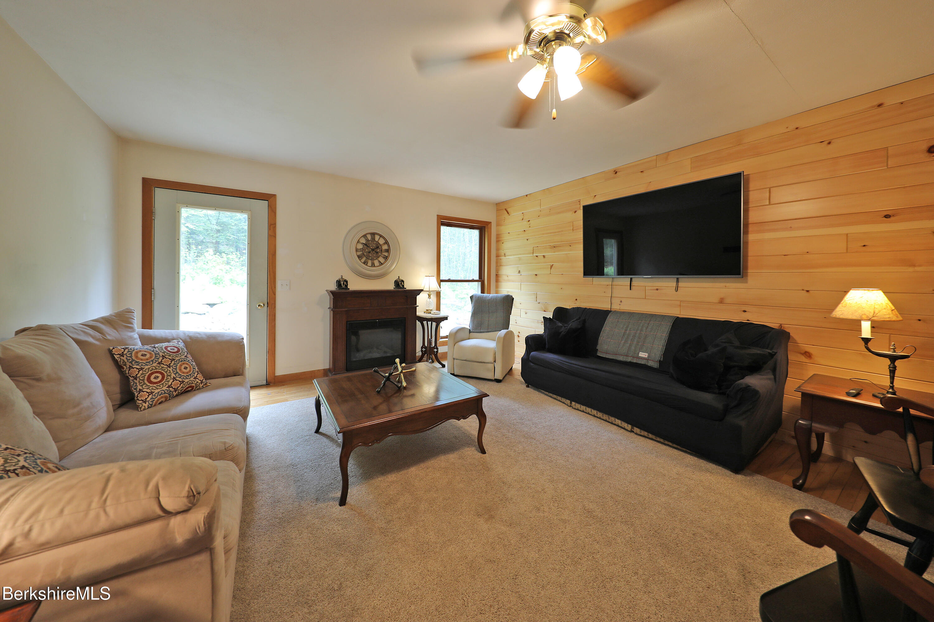 289 Algerie Road Becket, MA 01223 - Photo 12 of 33 a living room with furniture a flat screen tv and a fireplace