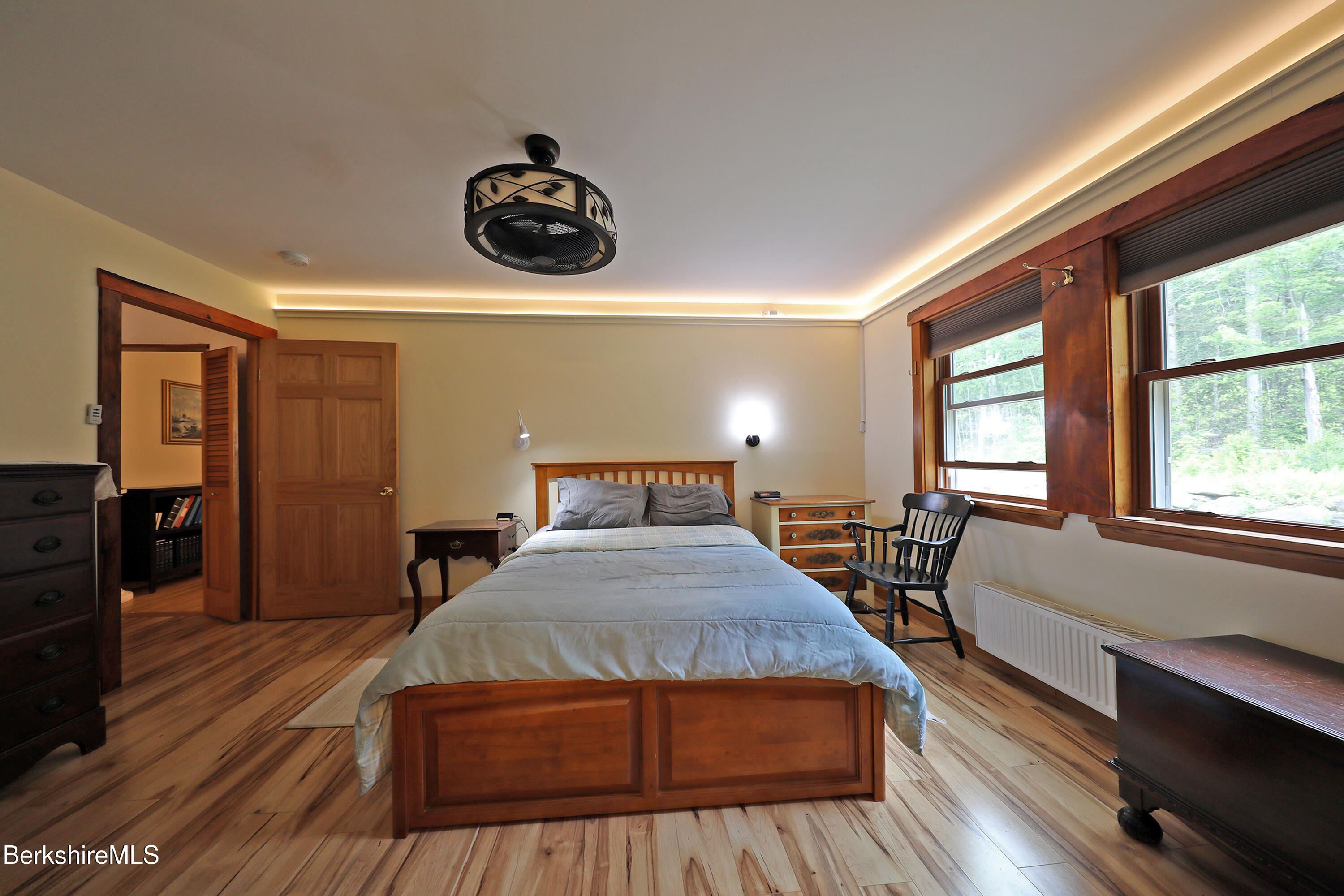 289 Algerie Road Becket, MA 01223 - Photo 13 of 33 a bedroom with a bed and wooden floor