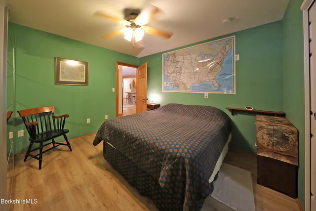 a bedroom with a bed and a chair