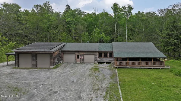 a view of a house with a yard and sitting area