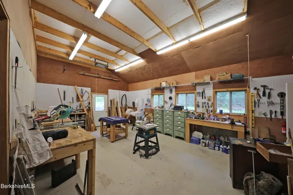 a room with gym equipment and large windows