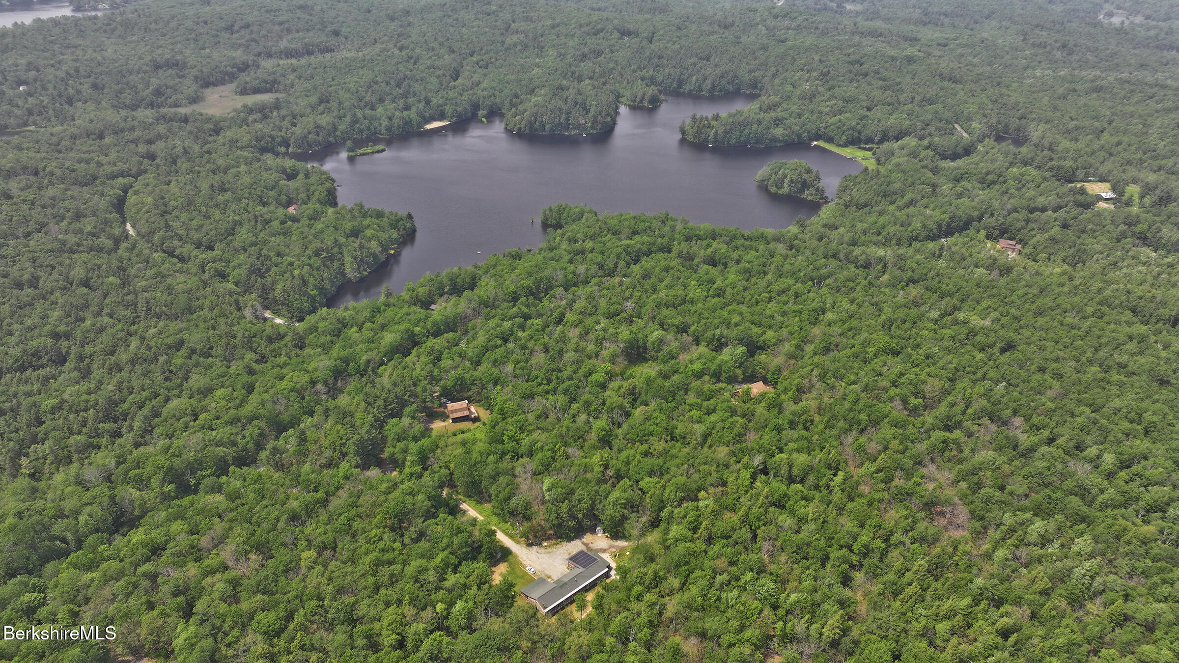 289 Algerie Road Becket, MA 01223 - Photo 4 of 33 a aerial view of a house with a yard and covered with green space