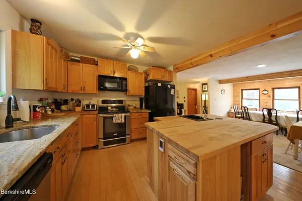a kitchen with a stove a sink and a refrigerator