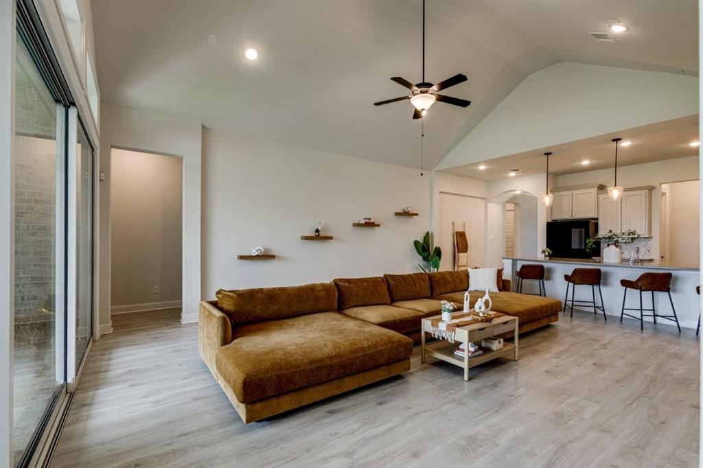 9613 Boulder Pt Road Oak Point, TX 75068 - Photo 12 of 28 Vaulted ceiling living area with wood-finish flooring