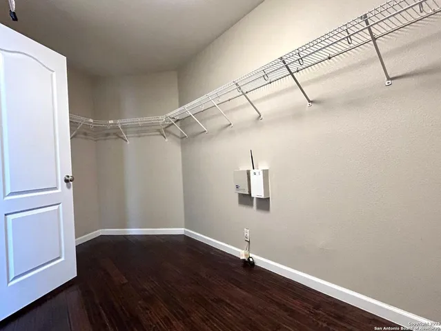 a view of a room with wooden floor