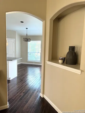 a view of a livingroom with wooden floor and windows
