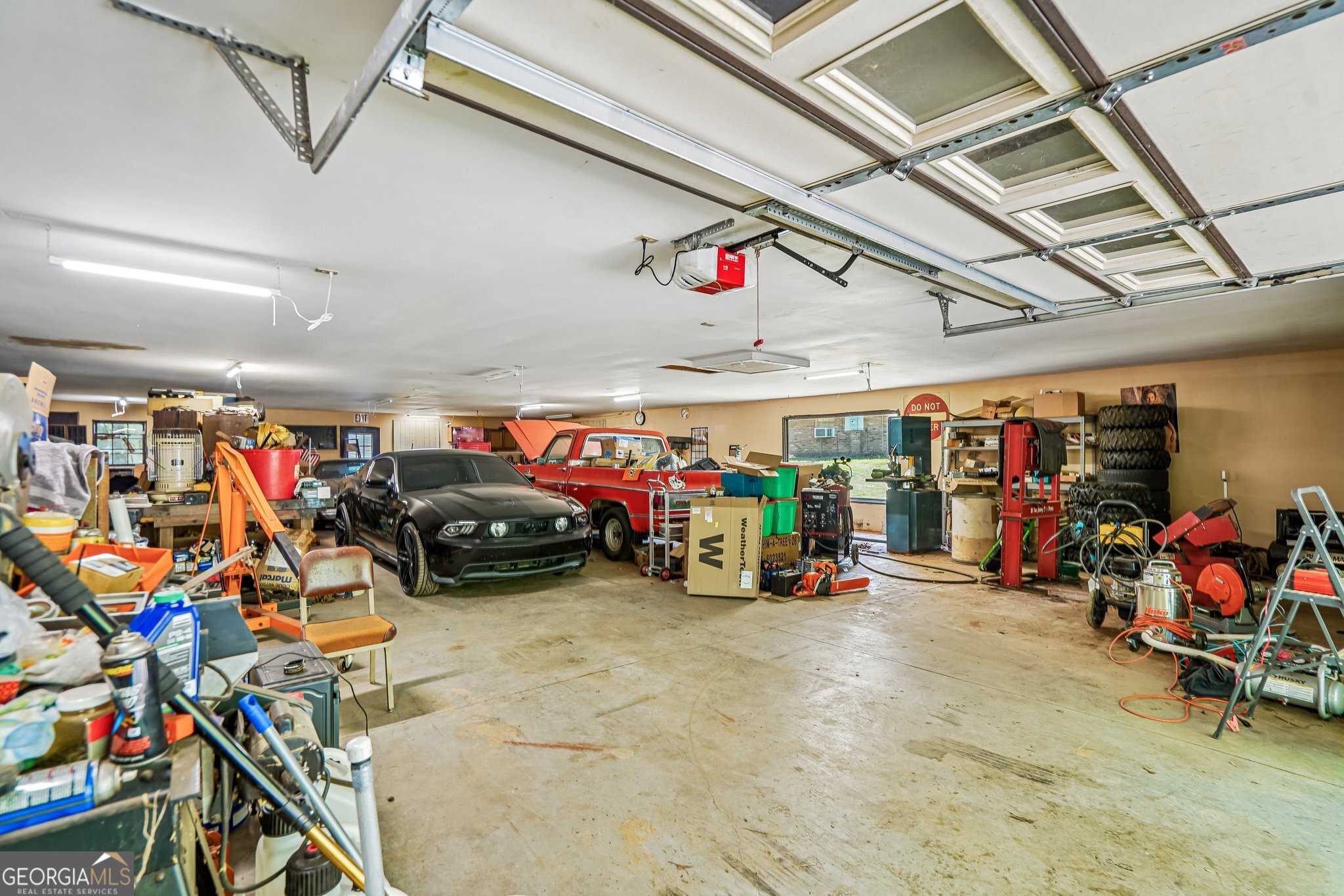 241 Busbin Road Fayetteville, GA 30215 - Photo 34 of 45 a view of a garage with a bike and car