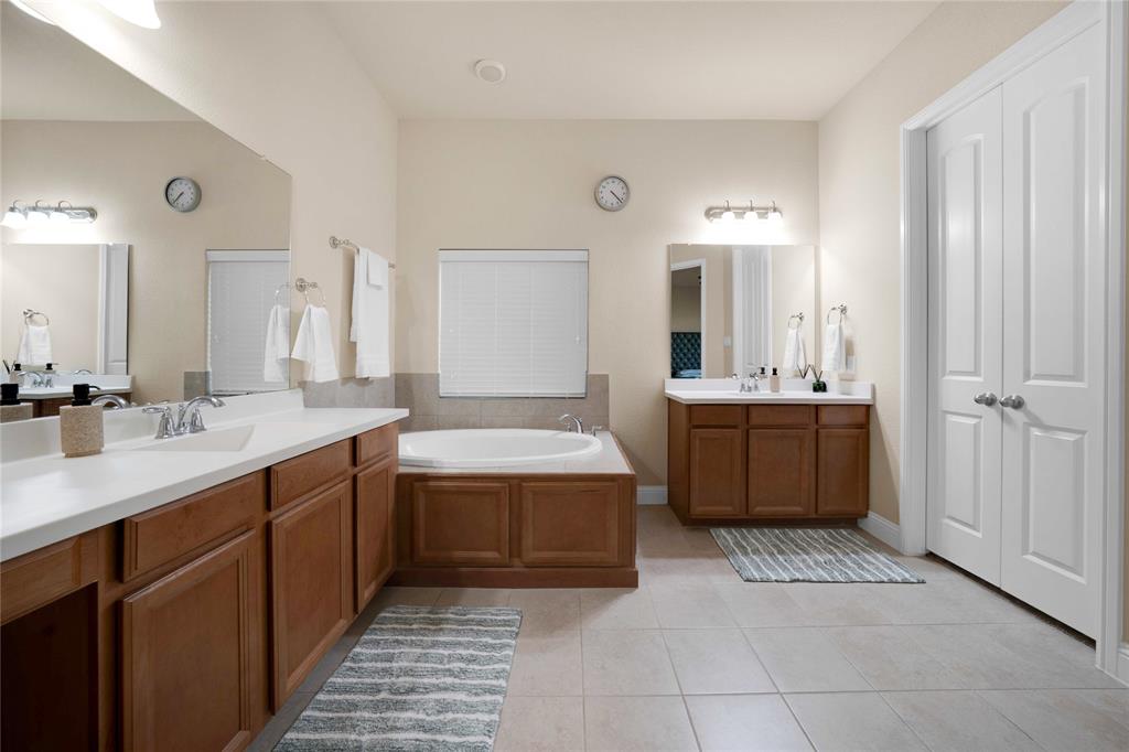 7024 Green Field Street Little Elm, TX 76227 - Photo 11 of 27 a bathroom with a tub a sink and mirror