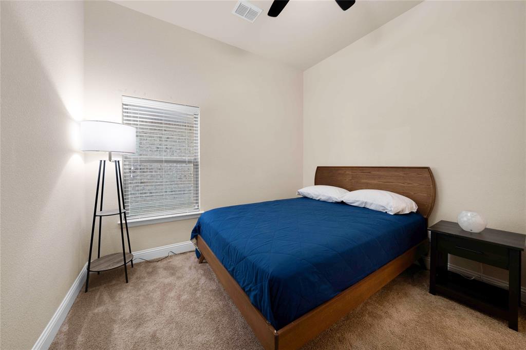 7024 Green Field Street Little Elm, TX 76227 - Photo 12 of 27 a bedroom with a bed and a window