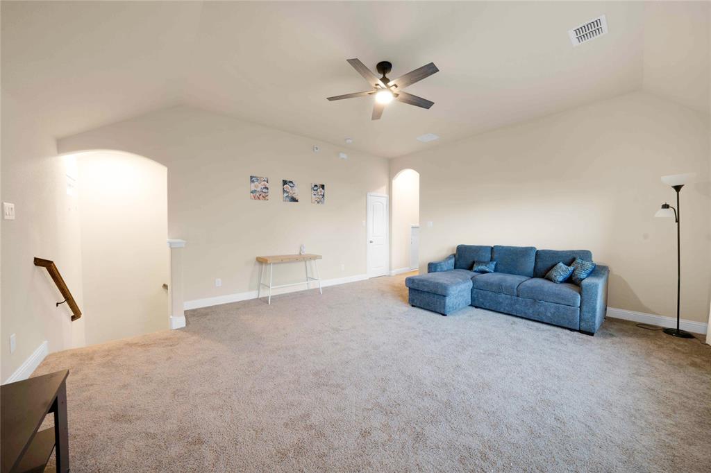 7024 Green Field Street Little Elm, TX 76227 - Photo 14 of 27 a living room with furniture and a chandelier