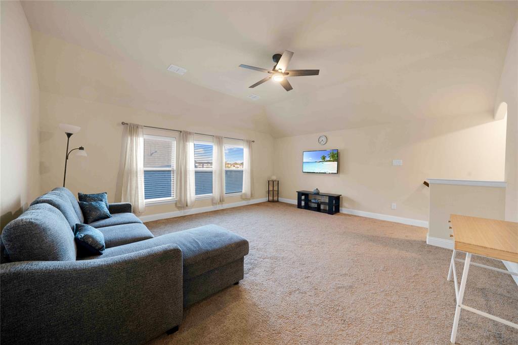 7024 Green Field Street Little Elm, TX 76227 - Photo 15 of 27 a living room with furniture and a large window