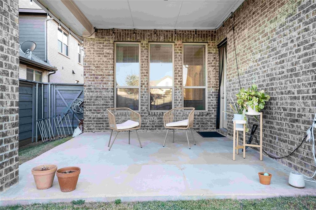 7024 Green Field Street Little Elm, TX 76227 - Photo 18 of 27 a view of a patio with table and chairs and potted plants