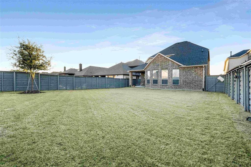 7024 Green Field Street Little Elm, TX 76227 - Photo 19 of 27 a front view of a house with a yard and fence