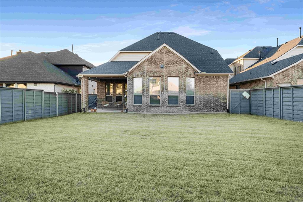 7024 Green Field Street Little Elm, TX 76227 - Photo 20 of 27 a front view of a house with a garden