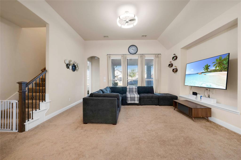 7024 Green Field Street Little Elm, TX 76227 - Photo 6 of 27 a living room with furniture and a flat screen tv