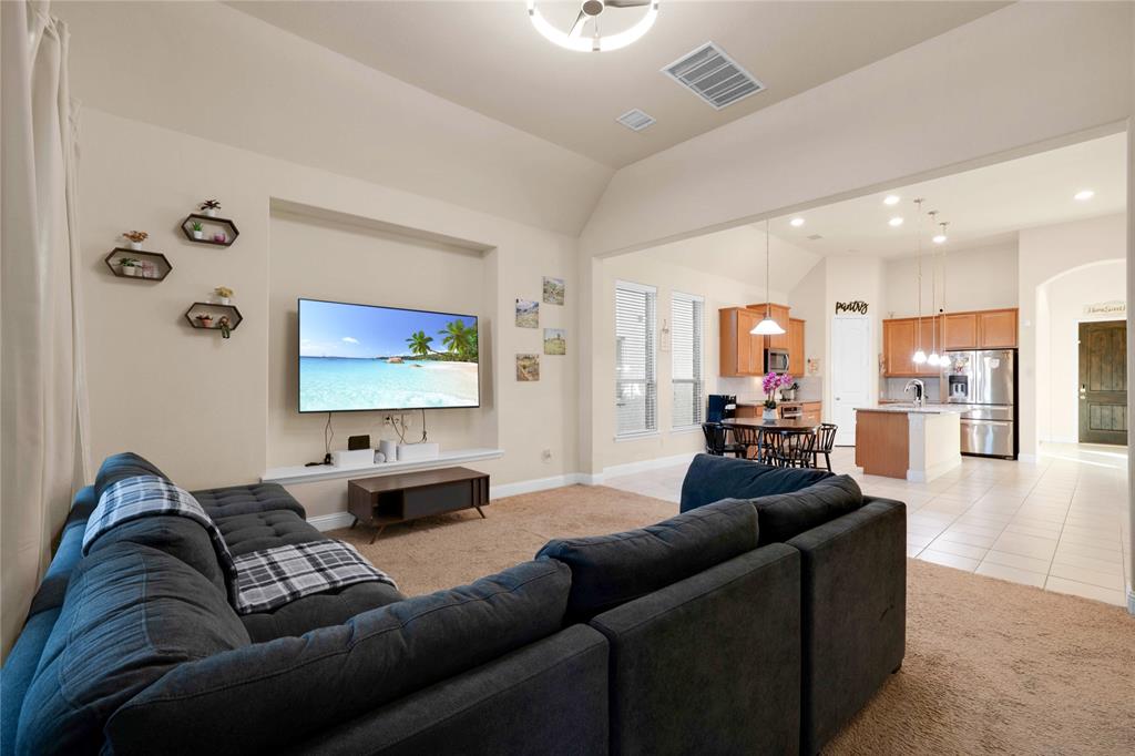 7024 Green Field Street Little Elm, TX 76227 - Photo 7 of 27 a living room with furniture and a flat screen tv